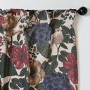 Närbild på blommig gardin i linne med botaniskt mönster i gröna, röda och beige toner