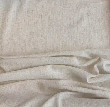 Ljust enfärgat gardintyg i linnelook med mjuk vävd struktur, tyget Lova uppvisat i tygveck.
