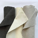 Tre rullar av ljushärdig uteväv i naturtoner där tyget är uppvikt för att visa struktur och väv. Slitstarkt tyg som passar för gardiner, dynor och andra utomhustextilier.