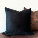 Svart kuddfodral i sammet Morgan placerad på soffa tillsammans med andra kuddar