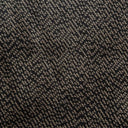 Närbild på Bengt möbeltyg med tät väv och melerad struktur i bruna och svarta nyanser