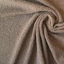 Brunt möbeltyg Mimmi draperat i spiral för att visa fall och struktur. Mjukt men hållbart tyg i 100 % polyester.