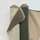 Dubbelvävt möbeltyg Romeo i naturtoner med små geometriska mönster. Tyget visas på rulle och uppvikt för att visa struktur och väv. Slitstarkt tyg i bomull och polyester.