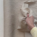 Video där en hand känner på tyget Sabina i 100 % tvättat linne och visar tygets struktur och naturliga fall.